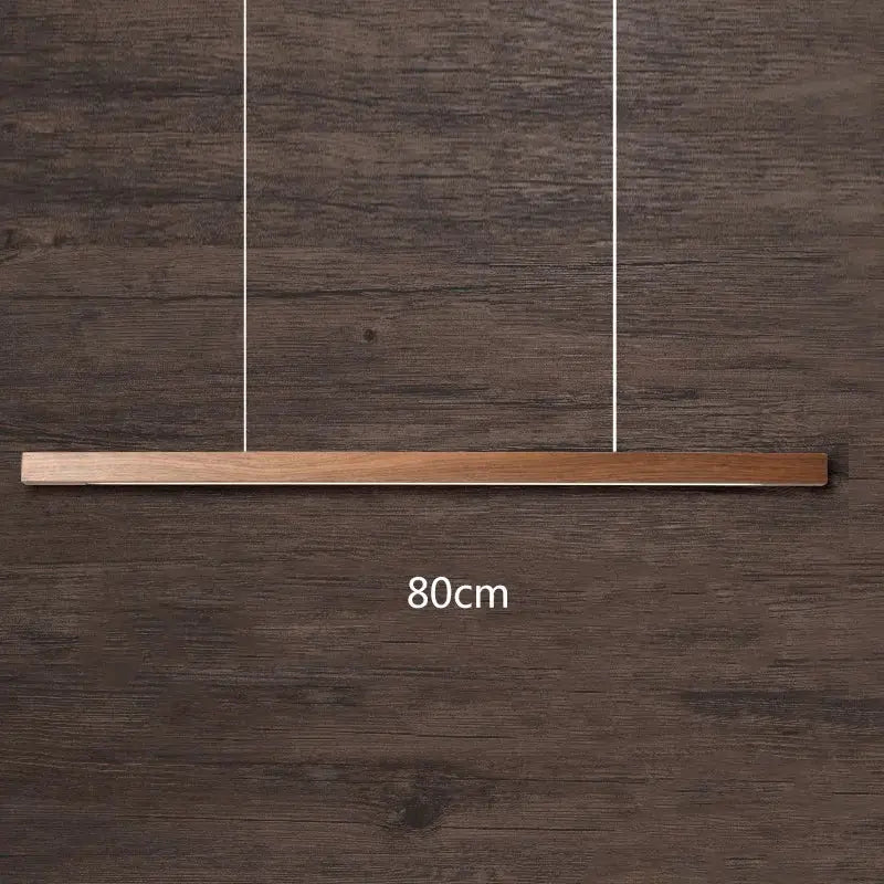 Minimalist black walnut log pendant light with sleek rectangular design and natural wood grain finish for dining room decor