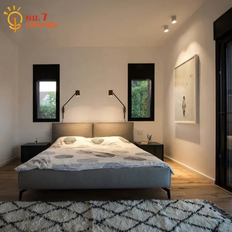 Modern gray upholstered bed with minimalist design paired with black walnut swing arm wall lamp for bedroom decor