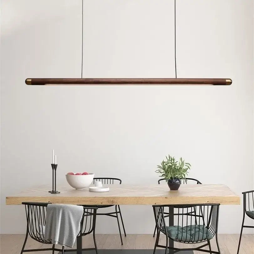 Minimalist black walnut wood pendant light with brass ends hangs above dining table for modern decorbites pendant lights