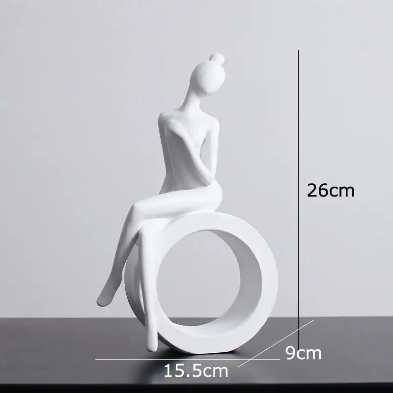 White ceramic abstract resin sculpture of seated woman with hair in bun on circular base for decorbites abstract decor