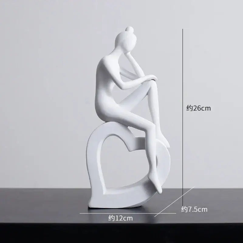 White ceramic figurine of seated woman on heart base minimalist black and white abstract resin sculpture decorbites abstract