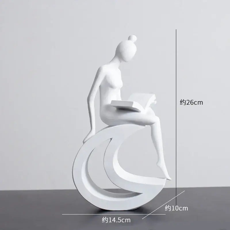 Minimalist black and white abstract resin sculpture of a woman reading on crescent base for living room decorbites abstract resin