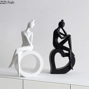 Two minimalist black and white abstract resin sculpture figurines by decorbites for living room decor
