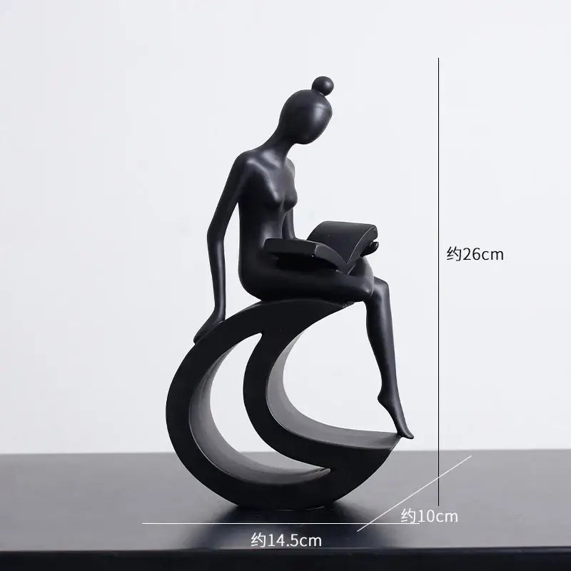 Minimalist black and white decorbites abstract resin sculpture of a glossy seated woman reading for living room decor