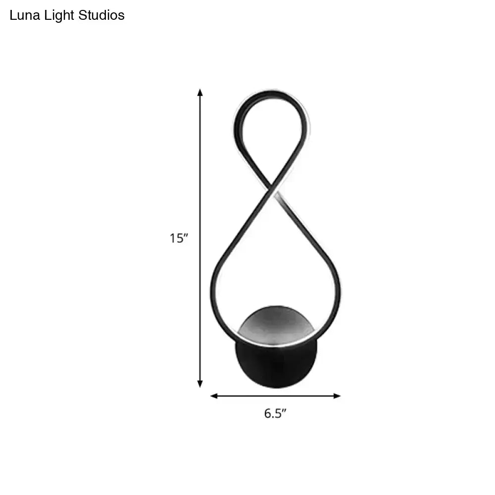 Black infinity-shaped acrylic led table lamp with sleek modern design and rounded base for minimalist black white decor