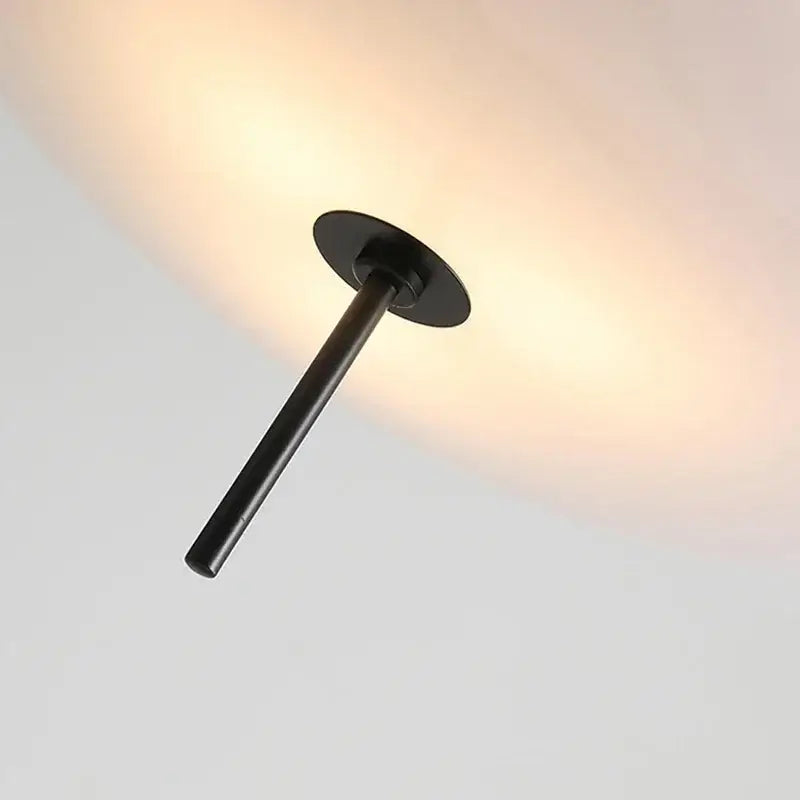 Minimalist black matte metal pendant light with circular base and slender stem for dining room acrylic pendant light