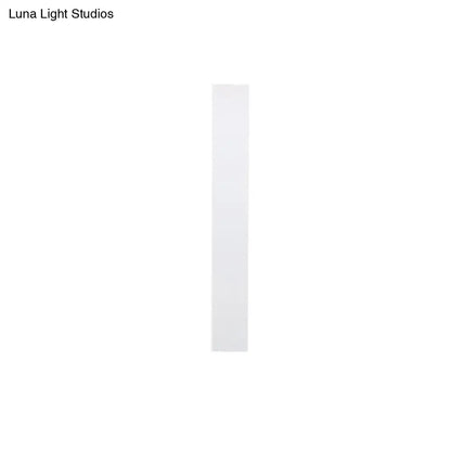 A sleek minimalist white rectangular strip of adhesive tape for direct wired aluminum shade sconce bedroom use