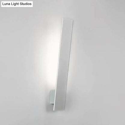 Minimalist white rectangular wall sconce with aluminum shade and direct wired design for modern bedroom use