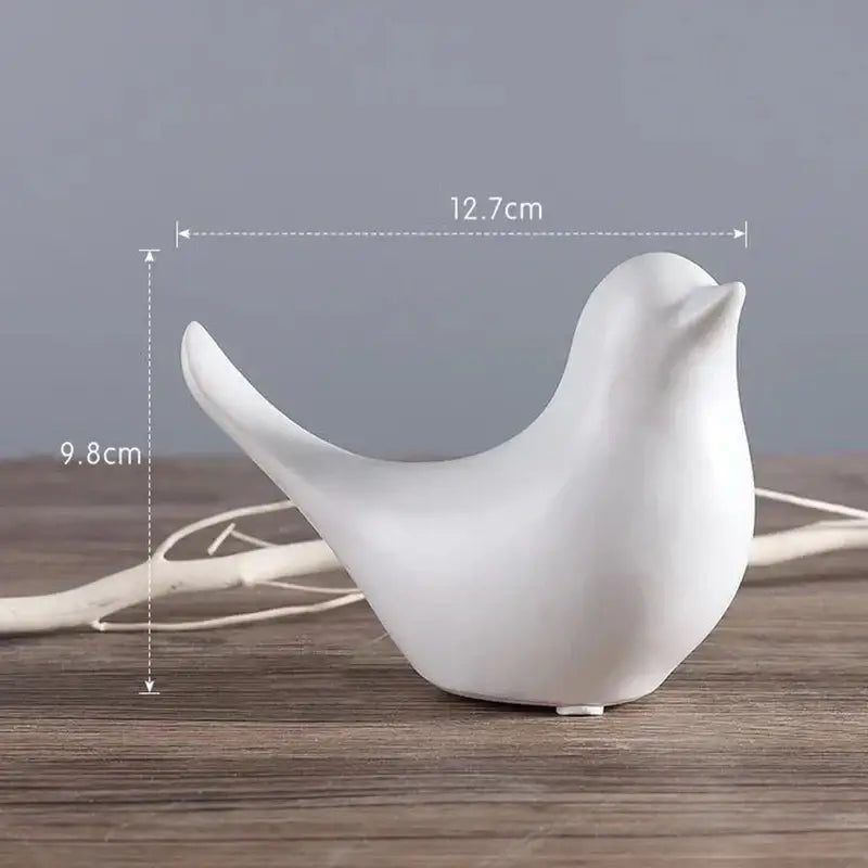 White ceramic bird figurine with smooth glossy finish in minimalist black and white bird figurine set for living room decor