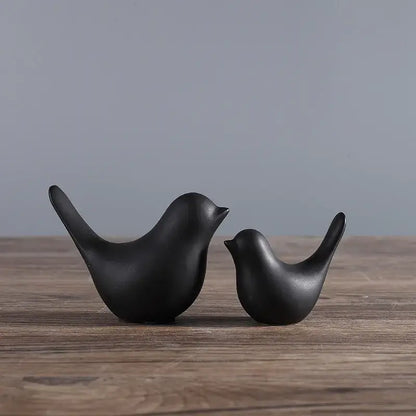 Minimalist black ceramic bird figurine set with smooth glossy surfaces for elegant living room decor