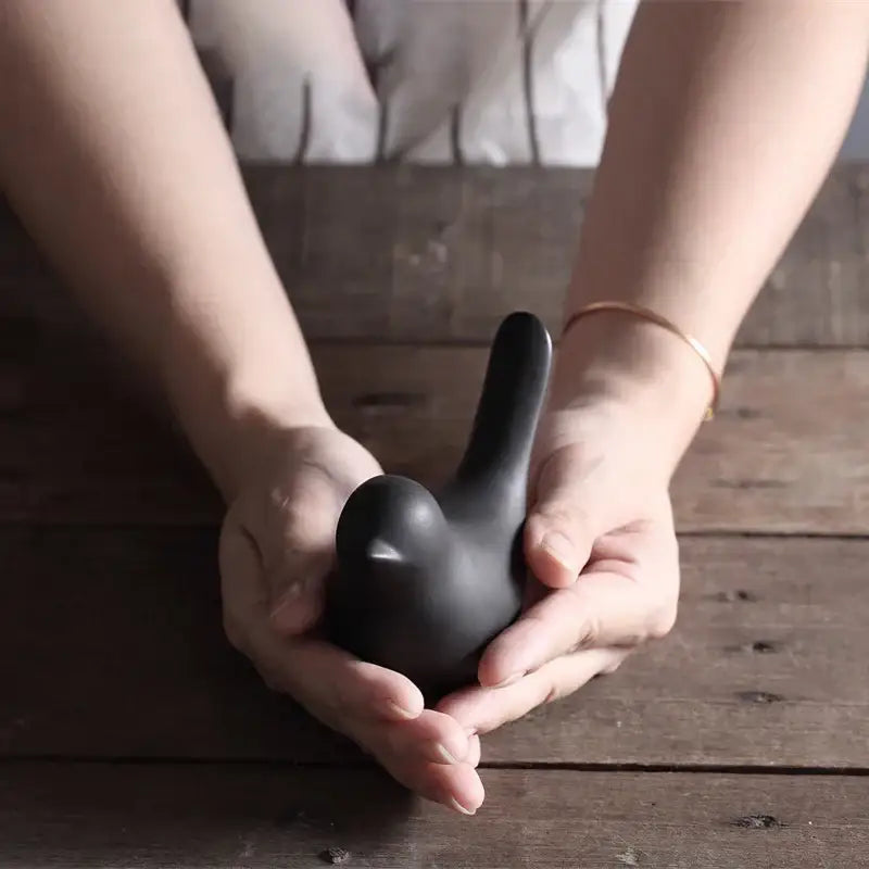 Minimalist black matte ceramic bird figurine with smooth curves in a bird figurine set for living room decor