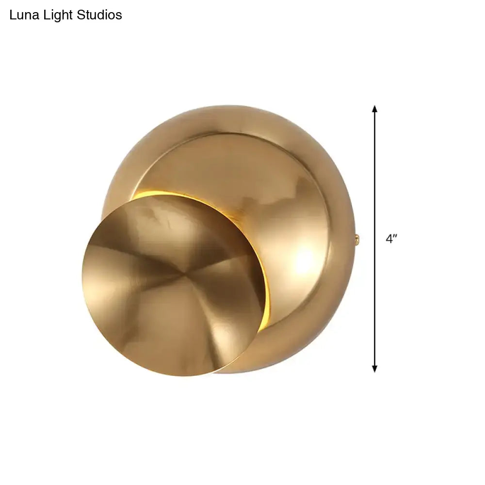 Brass-finished modern wall lamp with overlapping circular design and warm light for stairway in black and white