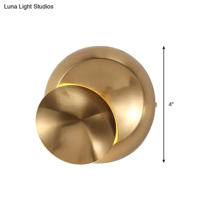 Brass-finished modern wall lamp with overlapping circular design and warm light for stairway in black and white