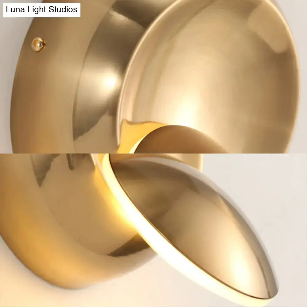 Brass-finished modern wall lamp with sleek curved design and integrated led lighting for stairway in black and white