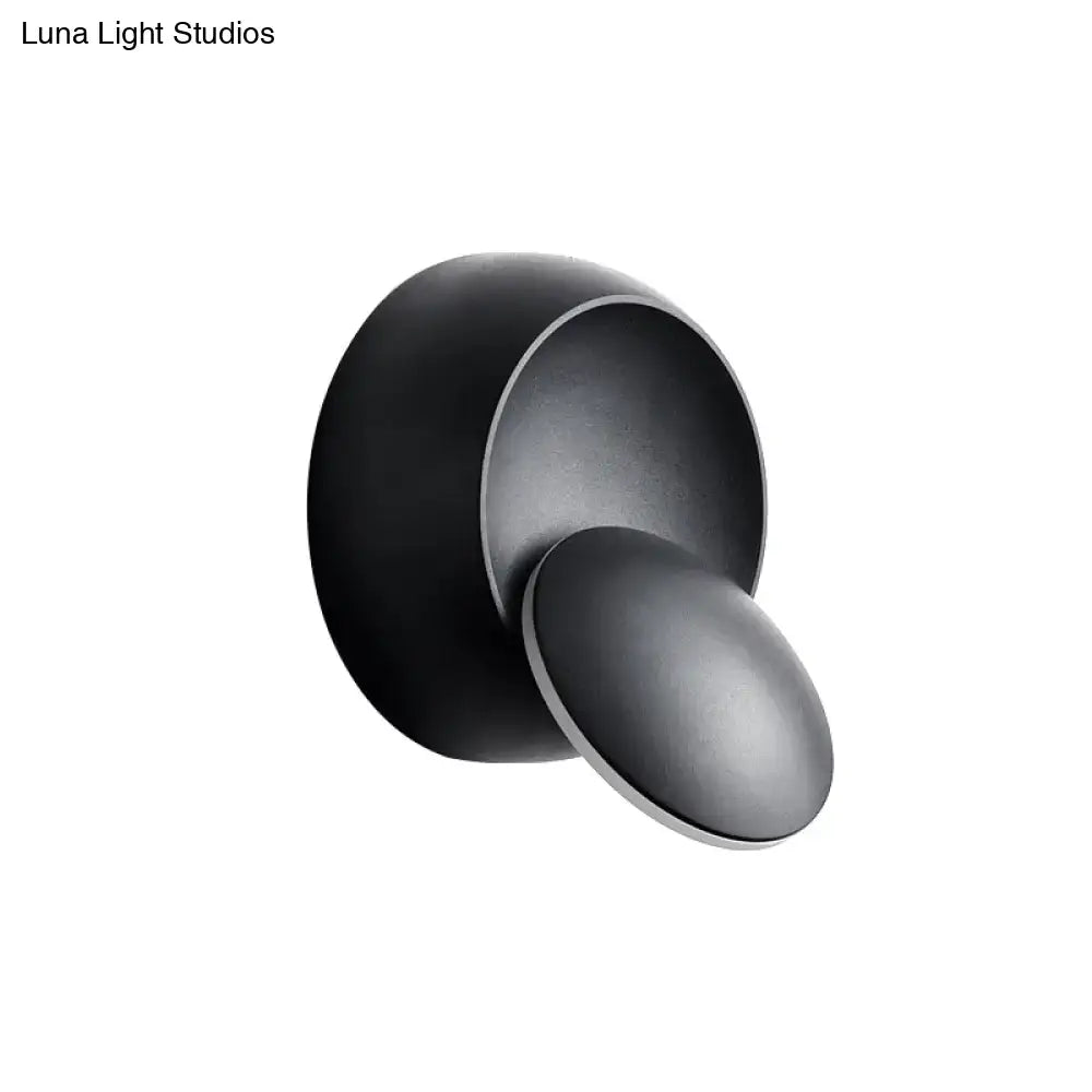 Matte black minimalist wall lamp with overlapping circular led design in black and white for stairway lighting