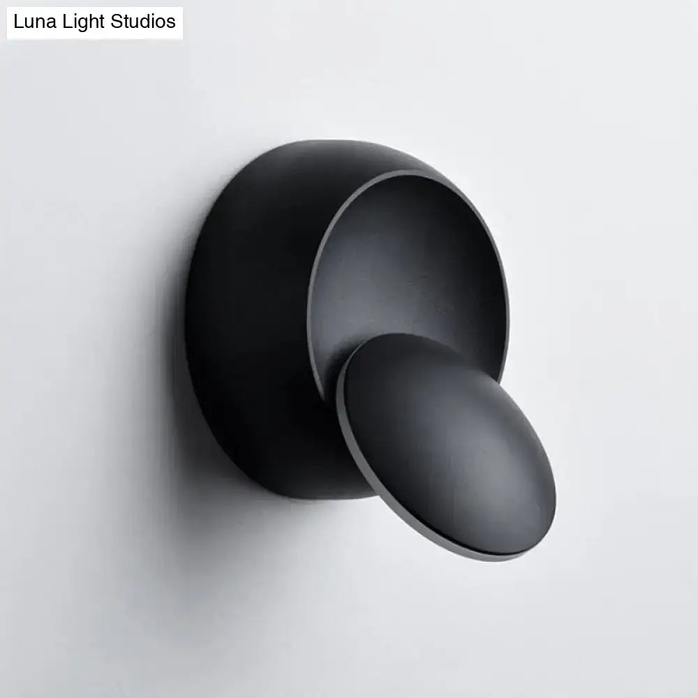 Minimalist black matte wall lamp with two concentric circles mounted on stairway wall in black white finish