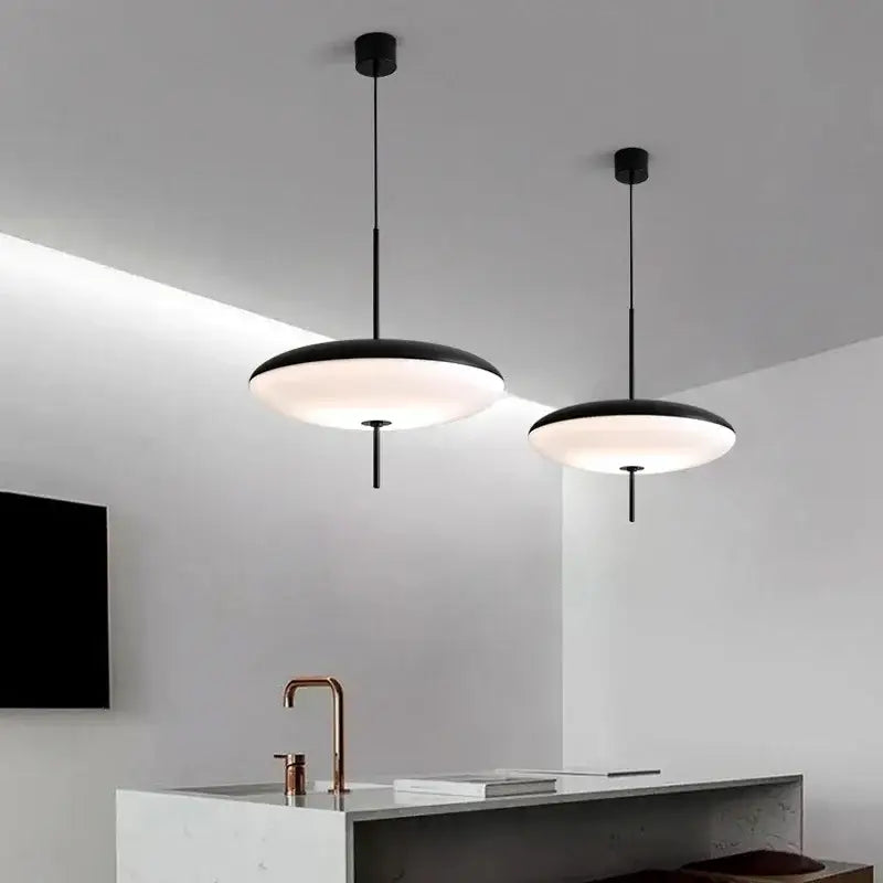 Two minimalist black and white designer pendant lights with frosted glass shades for dining room decorbites pendant light