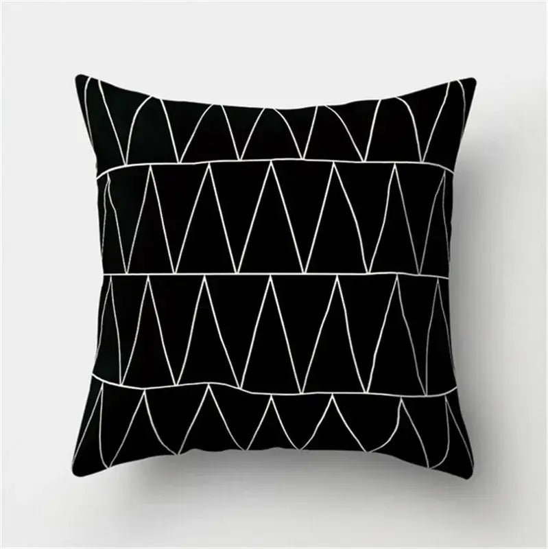 Black throw pillow with white geometric triangle patterns featuring black white flocking for decorbites living room decor