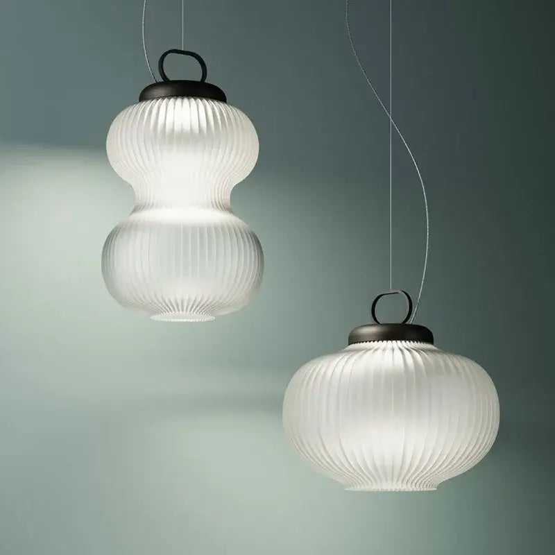 Minimalist white glass chandelier with frosted vertical ridges and dark metal tops for bedroom decorbites black style
