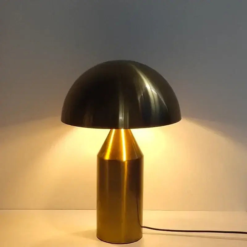 A sleek black and brass decorbites iron mushroom table lamp with a glossy dome shade for minimalist bedroom lighting