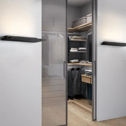 Modern minimalist sliding glass closet door with metallic frame and frosted panel paired with decorbites led wall light