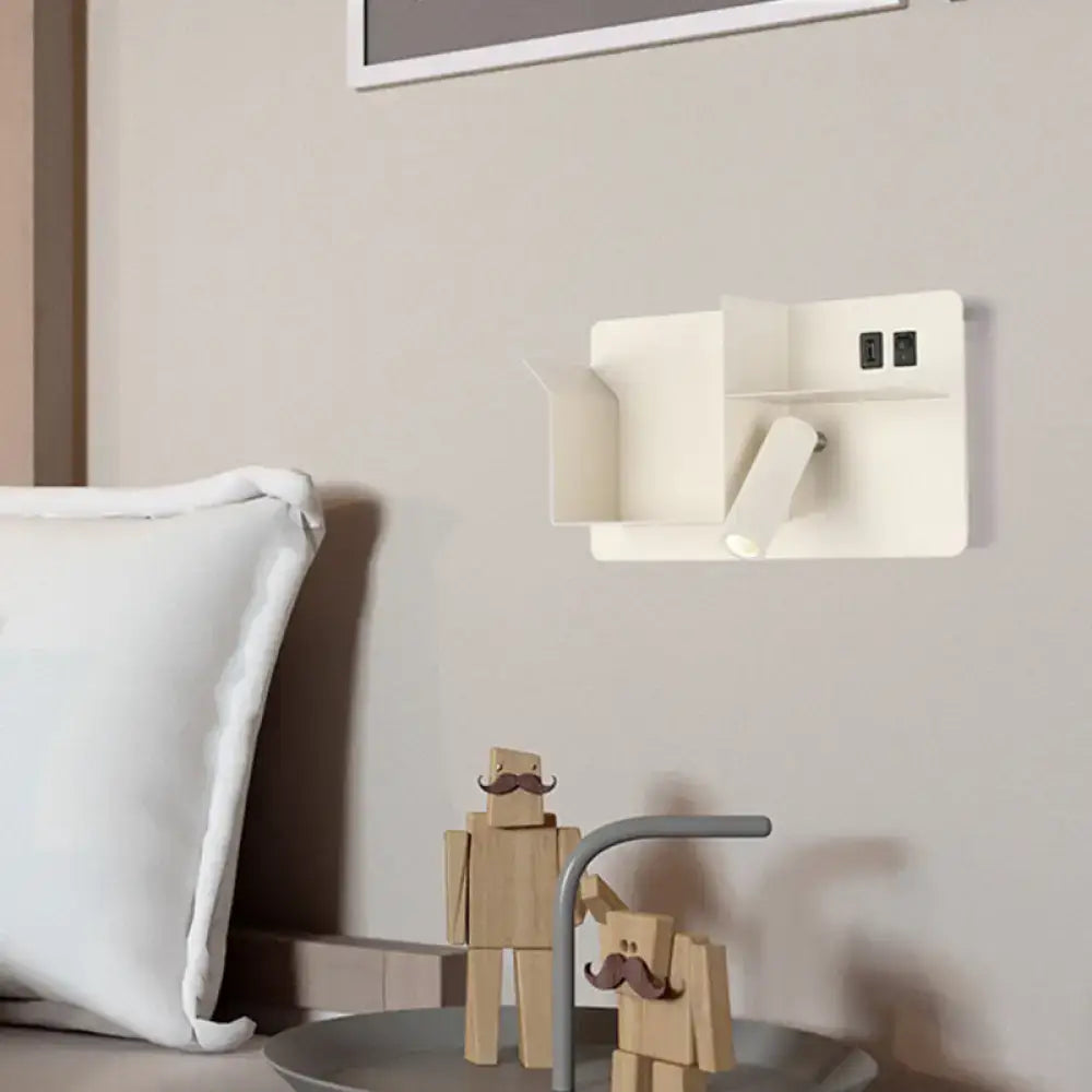 Minimalist black and white metal tubular wall light with bulb base and integrated power outlets for bedroom use