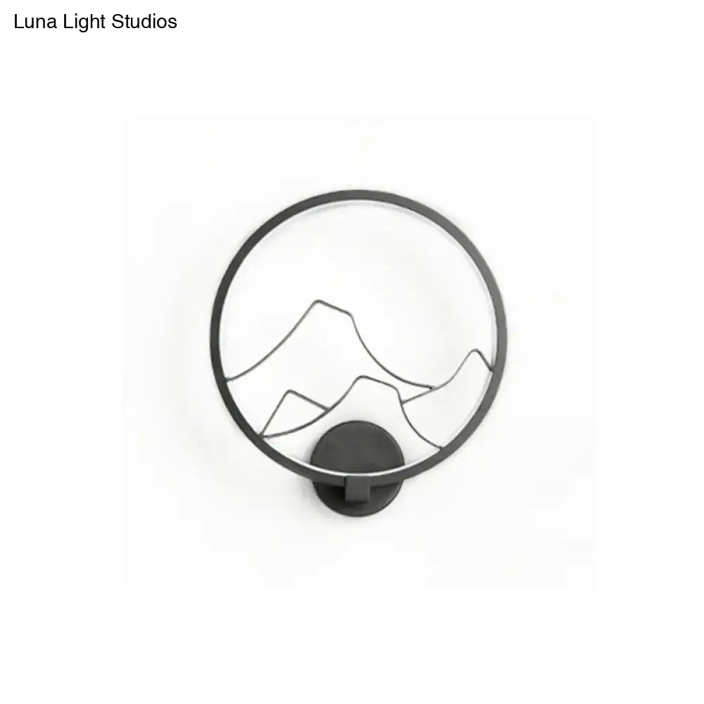 Black circular acrylic ring wall lamp with minimalist mountain silhouette design for bedroom use