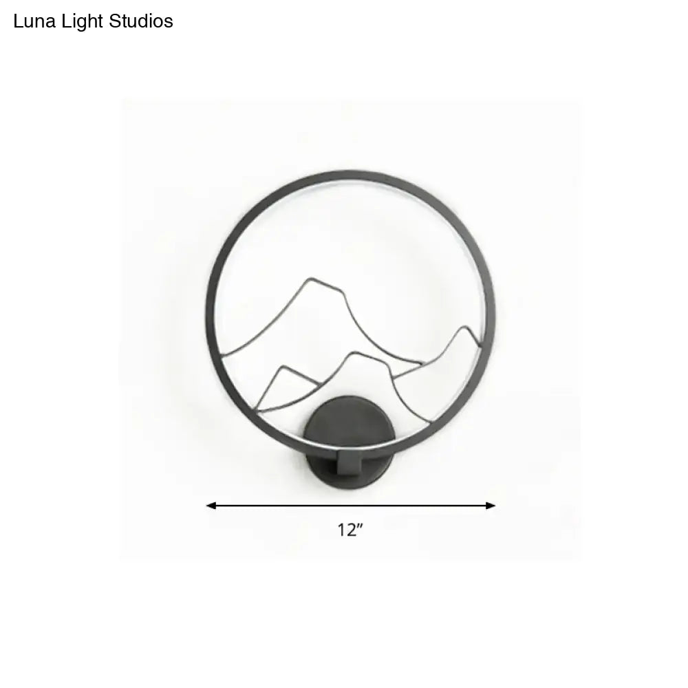 Minimalist black acrylic ring wall lamp with white mountain silhouette design ideal for bedroom wall lighting