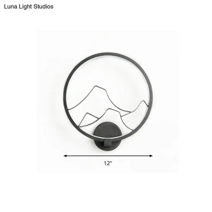 Minimalist black acrylic ring wall lamp with white mountain silhouette design ideal for bedroom wall lighting