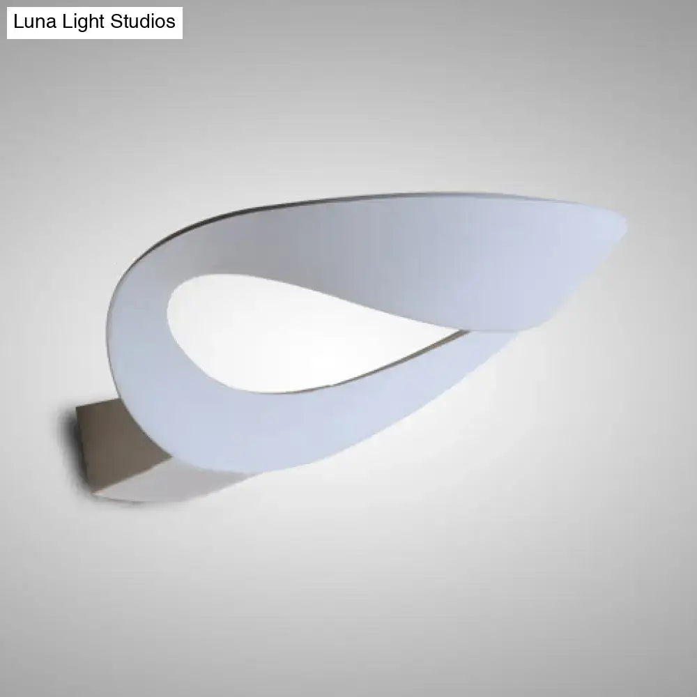 Minimalist black and white oval wall sconce with sleek leaf design metallic bracket and integrated led bulb wall light