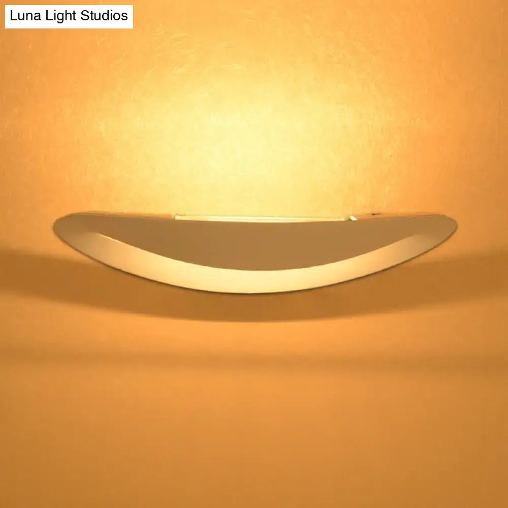 Minimalist black and white oval wall sconce with integrated led bulb and warm ambient lighting for bedroom wall light
