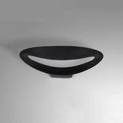 Minimalist black oval wall sconce with smooth matte finish and integrated led bulb for bedroom wall light