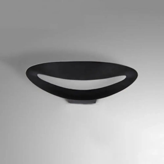 Minimalist black oval wall sconce with smooth matte finish and integrated led bulb for bedroom wall light
