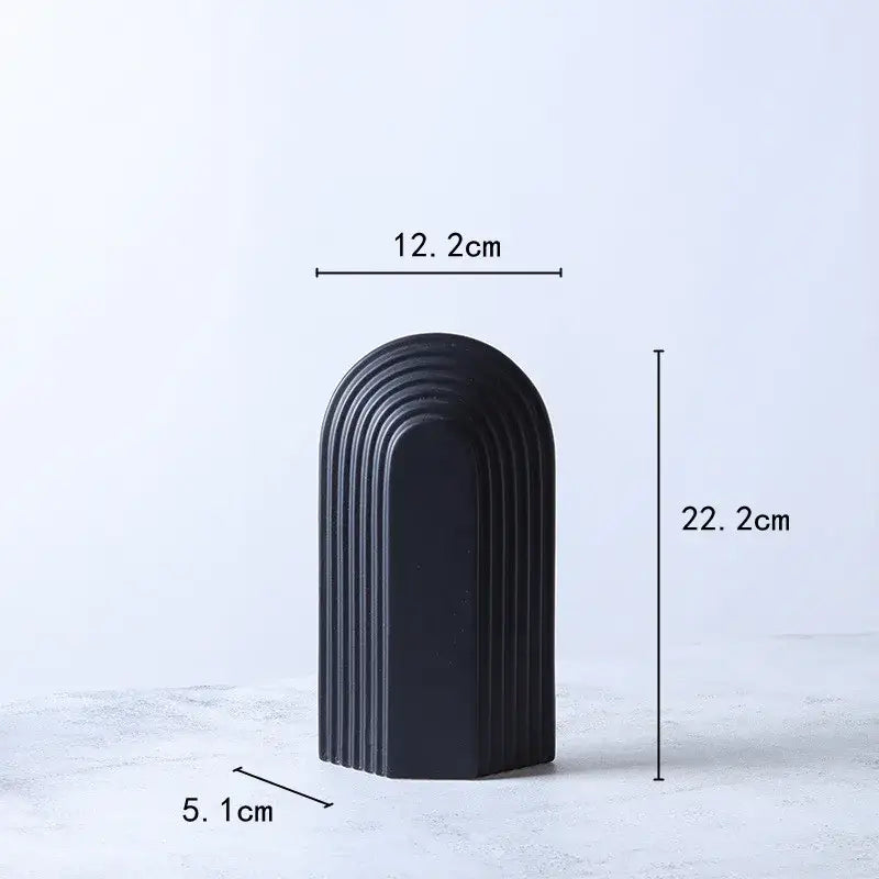 Black ceramic semicircular arch bookend with sleek concentric ridges for minimalist decorbites geometric ceramic decor figurines