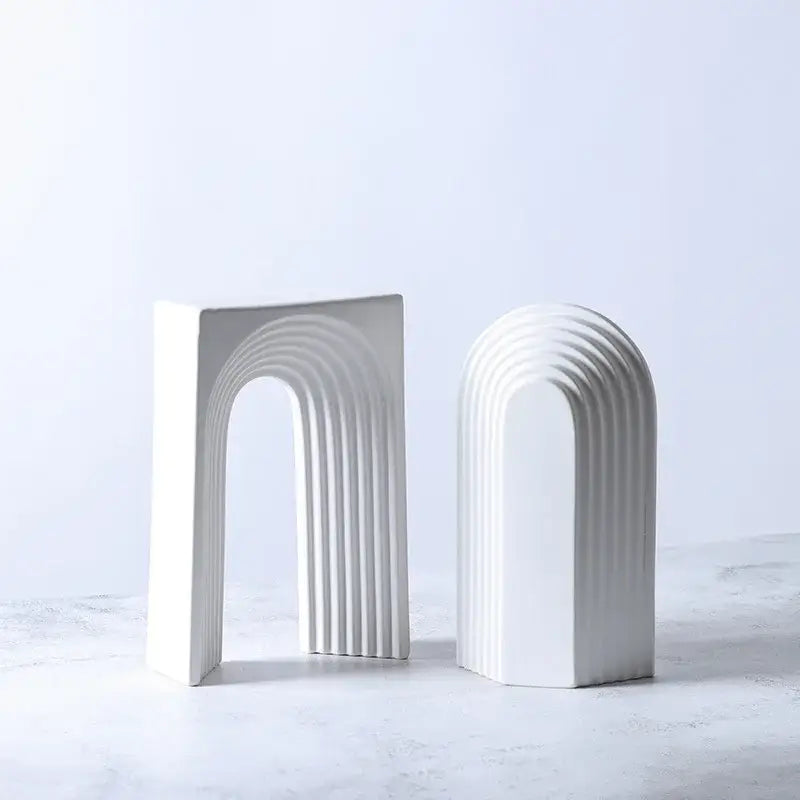 White ceramic semicircular arch bookends with concentric ridges minimalist decorbites geometric ceramic decor figurines