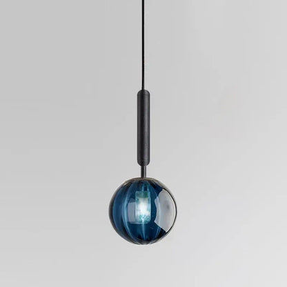 A sleek minimalist blue glass ball pendant light with a matte black stem for living room decorbites glass ball decor