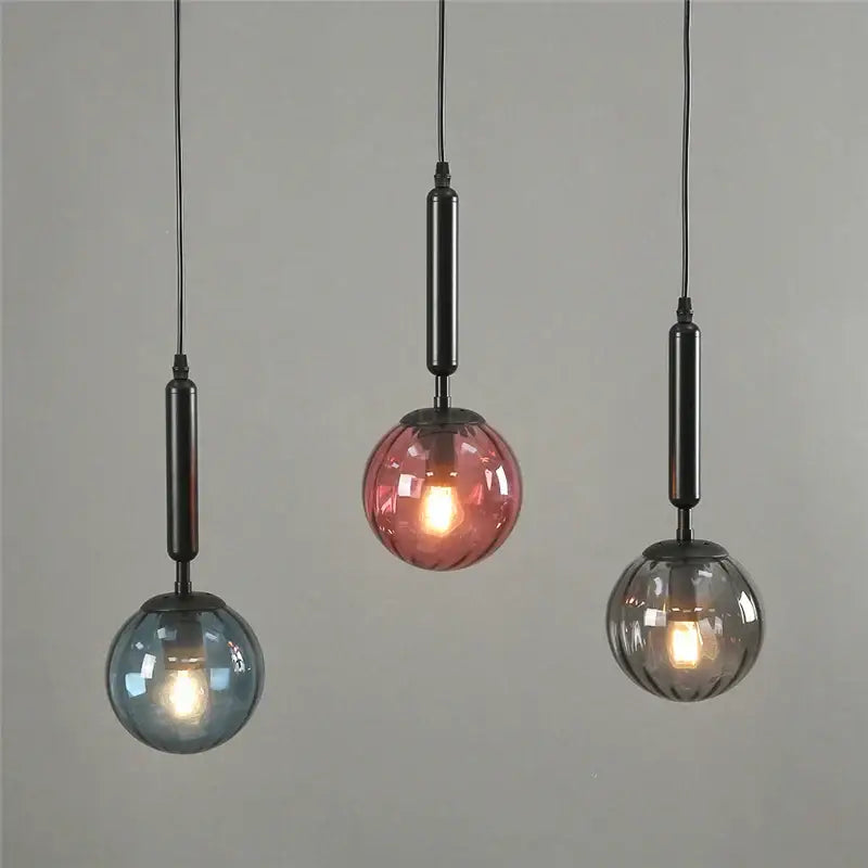 Minimalist blue pink and gray glass ball pendant light with black metal fixture by decorbites for living room decor