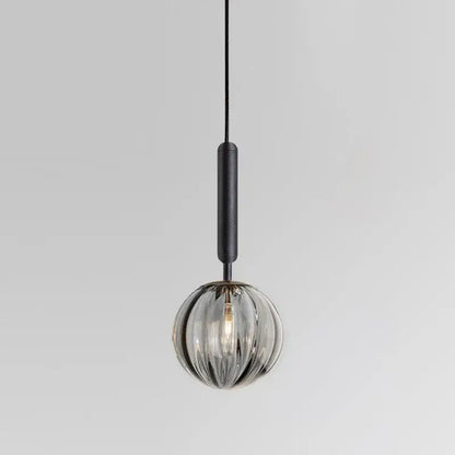A minimalist blue pink and gray decorbites glass ball pendant light with textured black cord for living room decor