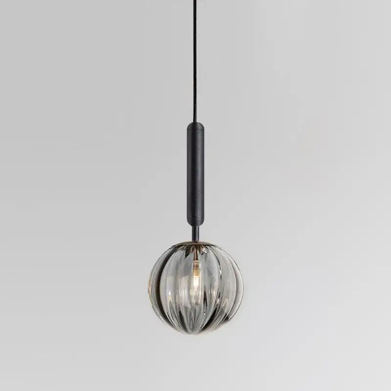 A minimalist blue pink and gray decorbites glass ball pendant light with textured black cord for living room decor
