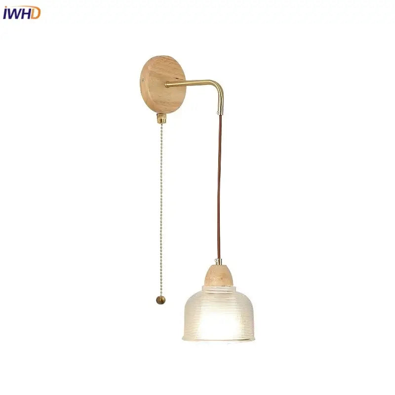 Minimalist brass wall light with natural wood base, clear glass ribbed shade, and pull chain switch for bedroom decorbites clear glass