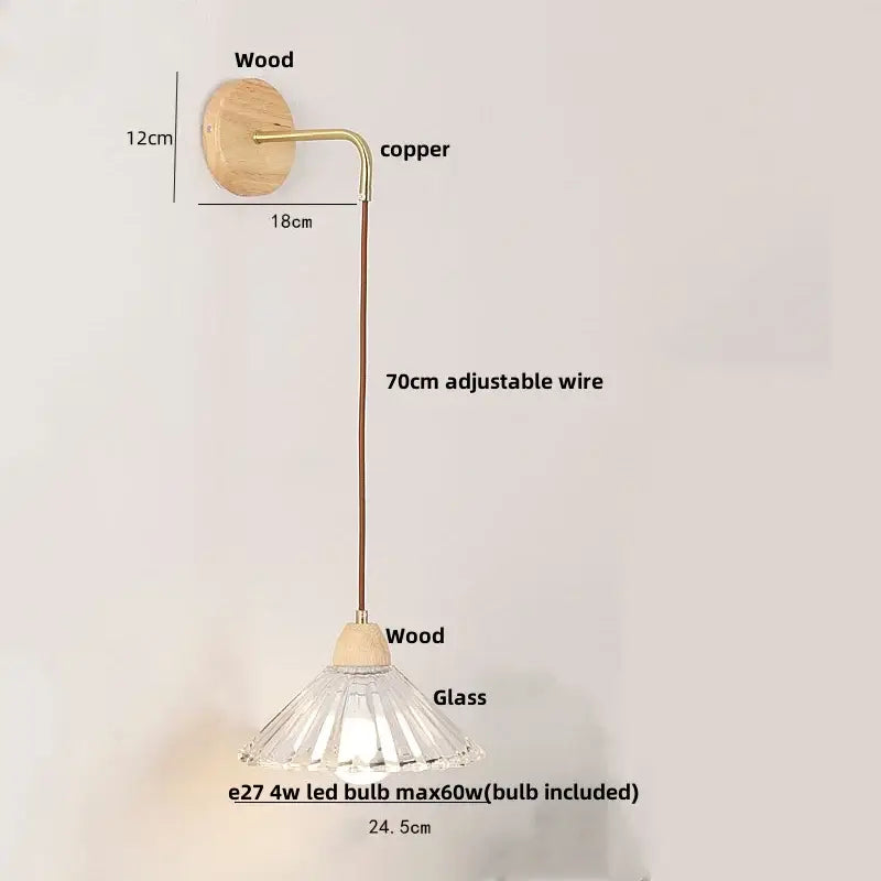 Minimalist wall light with clear glass faceted lampshade, wooden base, and copper wire arm for bedroom decorbites clear glass