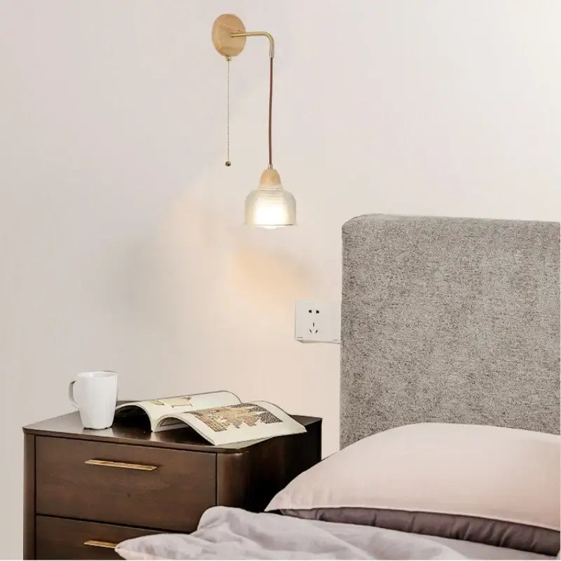 Minimalist wall light with brass arm wooden base and frosted clear glass shade for warm bedroom decorbites clear glass lighting