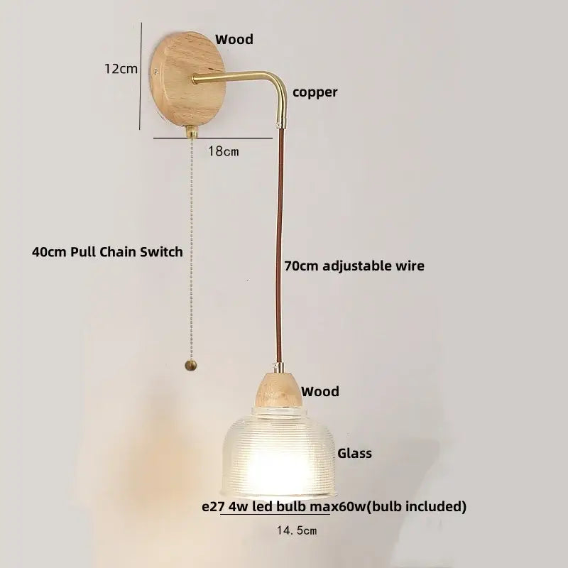Minimalist wall light with clear glass ridged shade, warm brass, natural wood base, and pull chain switch for bedroom decorbites clear glass
