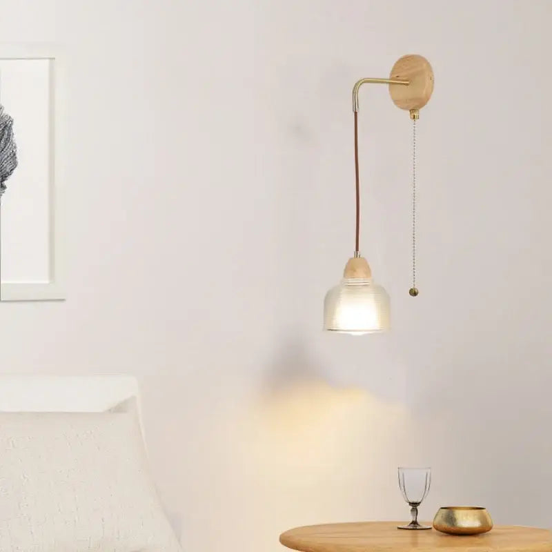 Minimalist wall light with brass arm wooden base and cap clear glass shade decorbites clear glass bedroom pull chain switch