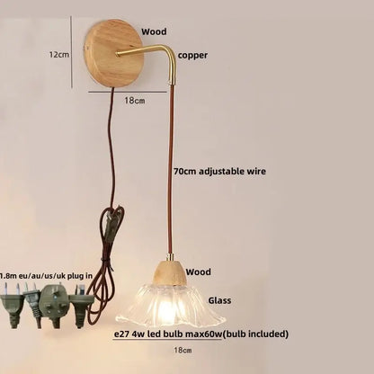 Minimalist brass and clear glass wall light with a round wooden base and adjustable 70cm cord by decorbites clear glass
