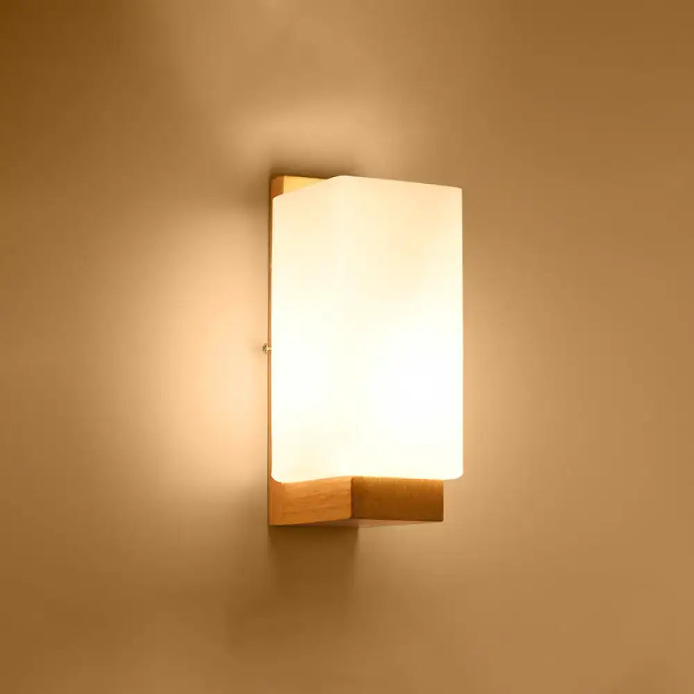 Minimalist brass and glass geometric wall sconce with warm-toned rectangular wooden frame and frosted glass diffuser