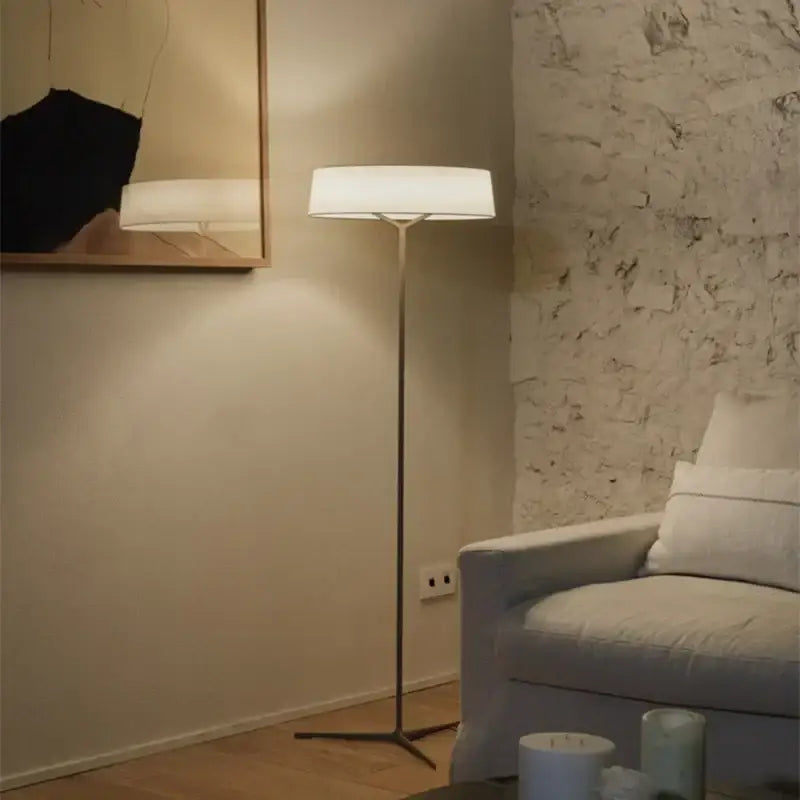 A minimalist dama pendant lamp with a white fabric shade and brass stand ideal for kitchen lighting