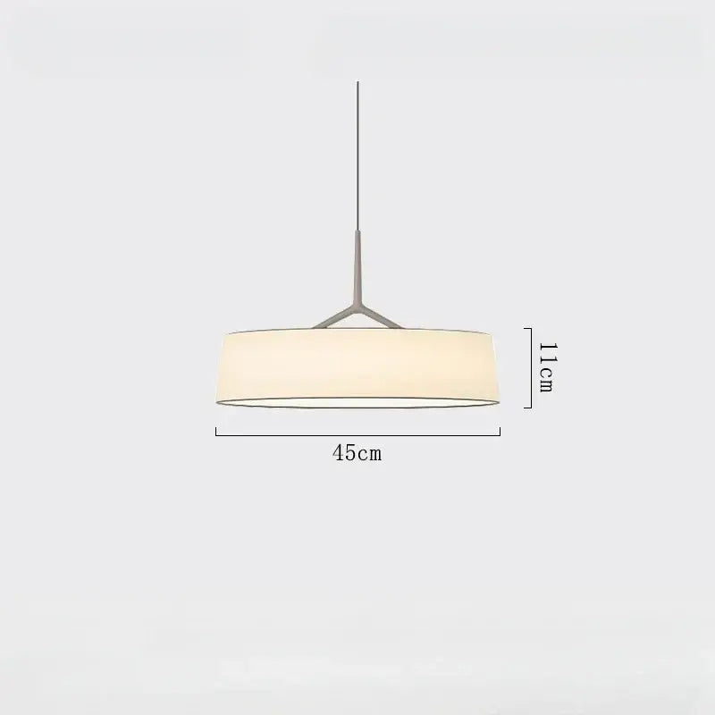 Minimalist brass and white fabric dama pendant lamp with matte metal frame and off-white shade for kitchens