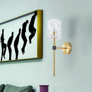 Gold-toned minimalist brass crystal cylindrical wall sconce for living room featuring a clear cylindrical crystal shade
