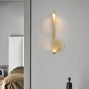 Minimalist brass curve led wall mount light in gold tone with sleek curved design and warm ambient lighting for living room